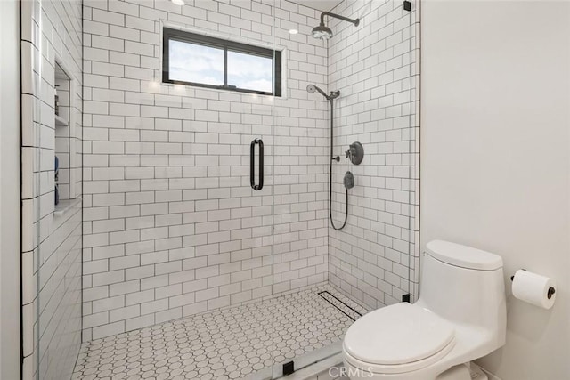 bathroom with toilet and an enclosed shower