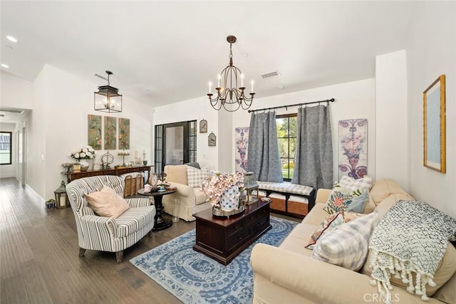 living room featuring dark hardwood / wood-style floors and a chandelier