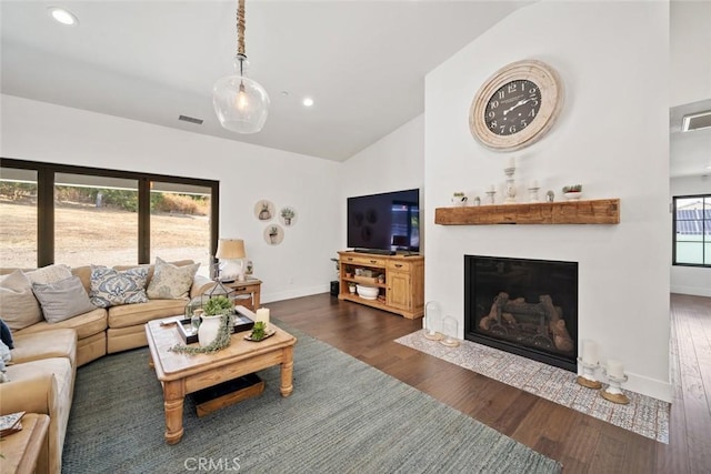 living room with dark wood-type flooring and lofted ceiling