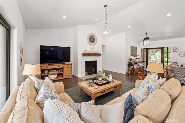 living room with dark hardwood / wood-style floors and vaulted ceiling