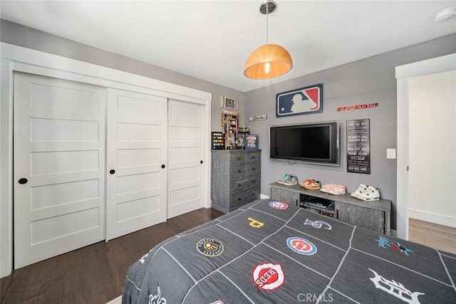 bedroom with a closet and dark wood-type flooring