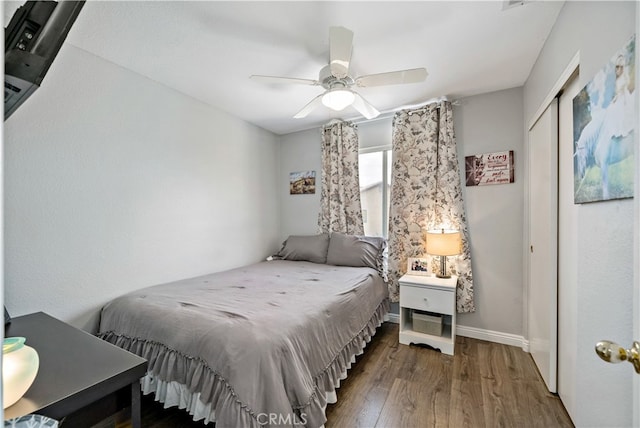 bedroom featuring a closet, ceiling fan, and dark hardwood / wood-style floors