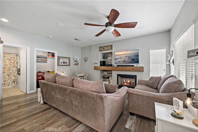 living room with wood-type flooring and ceiling fan