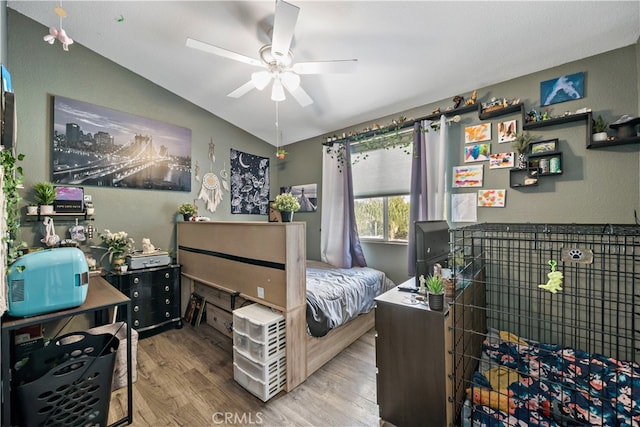 bedroom with wood-type flooring, vaulted ceiling, and ceiling fan