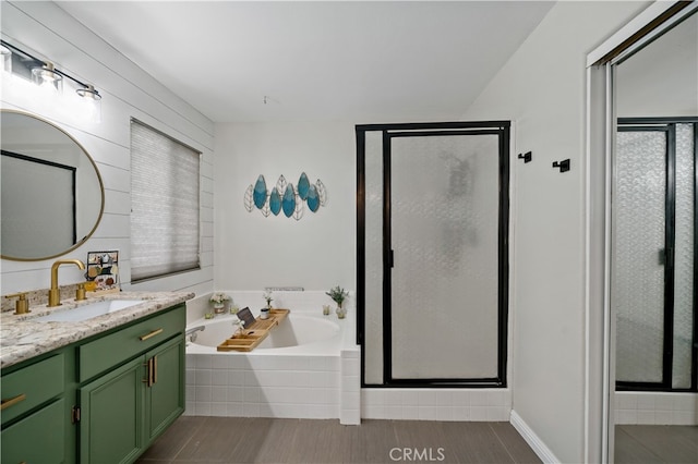 bathroom featuring vanity and separate shower and tub