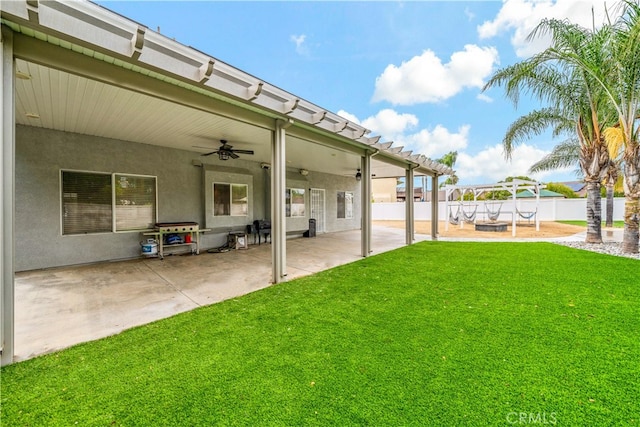 view of yard featuring ceiling fan and a patio area