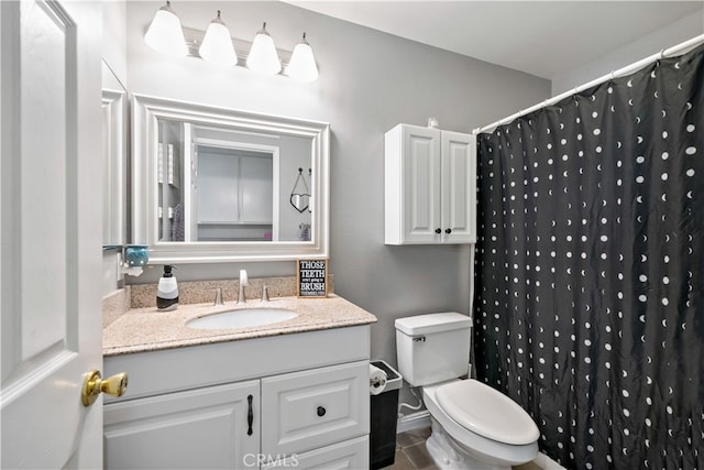 bathroom with walk in shower, vanity, and toilet