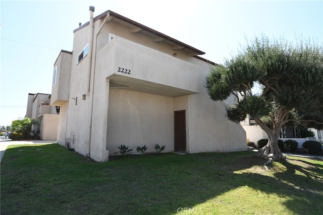 view of side of home featuring a lawn