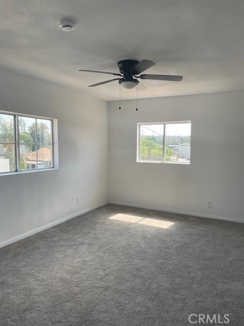 unfurnished room with carpet floors and ceiling fan