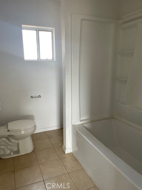 bathroom featuring bathtub / shower combination, tile patterned flooring, and toilet