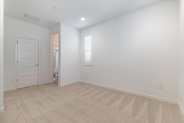 empty room featuring light colored carpet