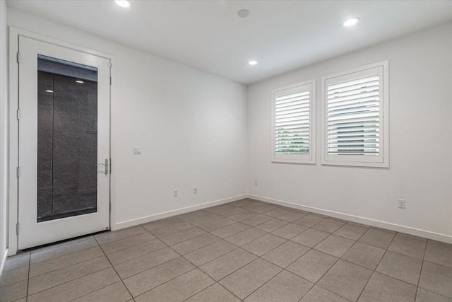 unfurnished room featuring light tile patterned floors