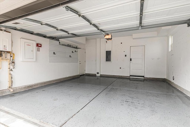 garage with a garage door opener, electric panel, and water heater