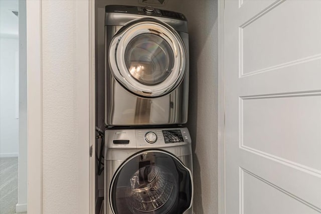 laundry room featuring stacked washer / dryer