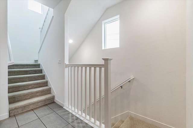 stairway with tile patterned floors