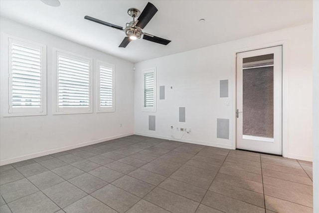 unfurnished room featuring ceiling fan and tile patterned flooring