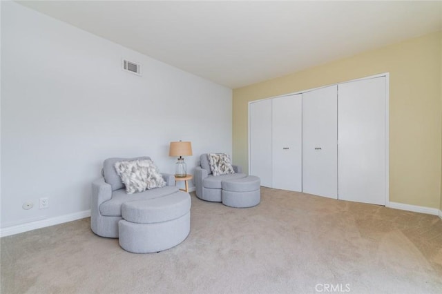 living area with light colored carpet