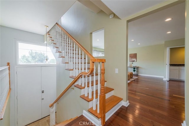 staircase with hardwood / wood-style floors