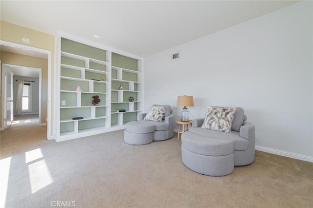 living area featuring carpet floors