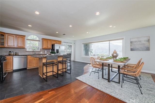 dining room with dark hardwood / wood-style flooring and sink