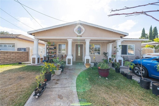 view of front facade with covered porch and a front lawn