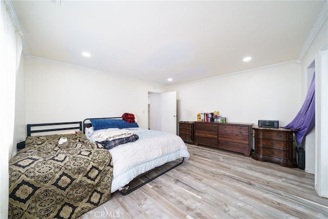 bedroom with light wood-type flooring and ornamental molding