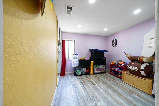 game room featuring light wood-type flooring