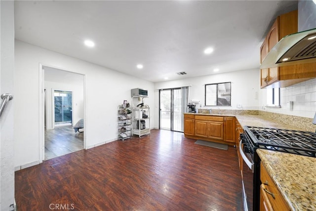 kitchen featuring gas stove, plenty of natural light, dark wood-type flooring, and ventilation hood