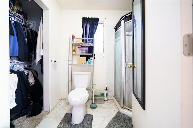 bathroom with toilet and walk in shower