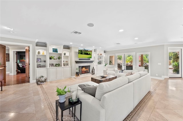 living room with a fireplace, french doors, and ornamental molding