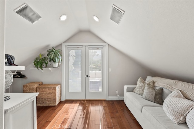 interior space with hardwood / wood-style flooring, french doors, and vaulted ceiling