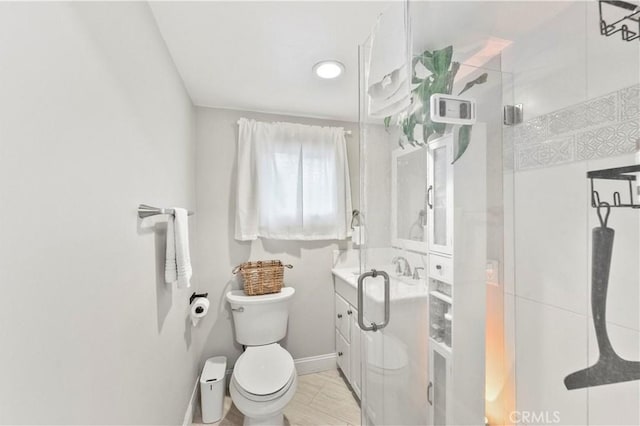 bathroom featuring toilet, an enclosed shower, and vanity