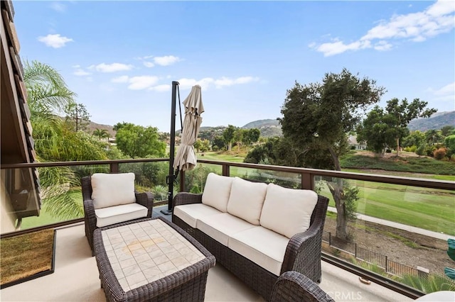 balcony featuring a mountain view and an outdoor living space