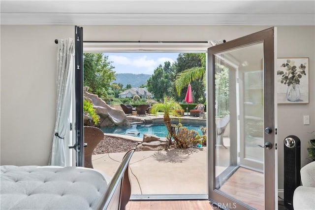 doorway to outside with french doors, crown molding, a mountain view, and light hardwood / wood-style flooring