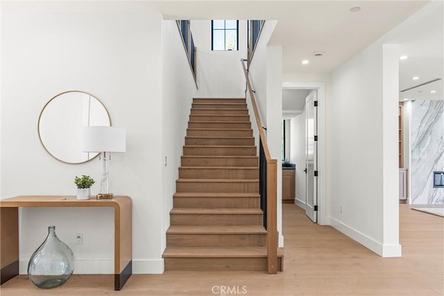 stairs featuring hardwood / wood-style floors