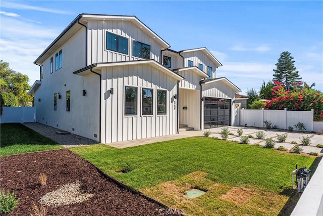 view of front of home with a front lawn and a garage