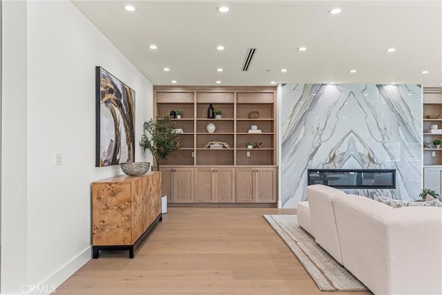 living room with a fireplace and light hardwood / wood-style flooring