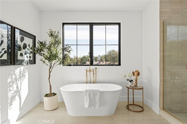 bathroom featuring tile patterned floors and independent shower and bath