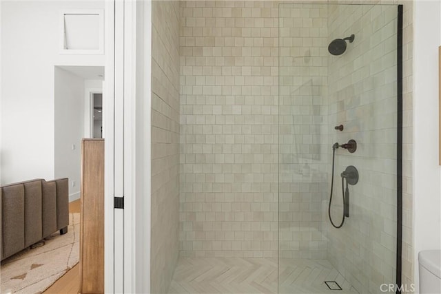 bathroom with a shower with door