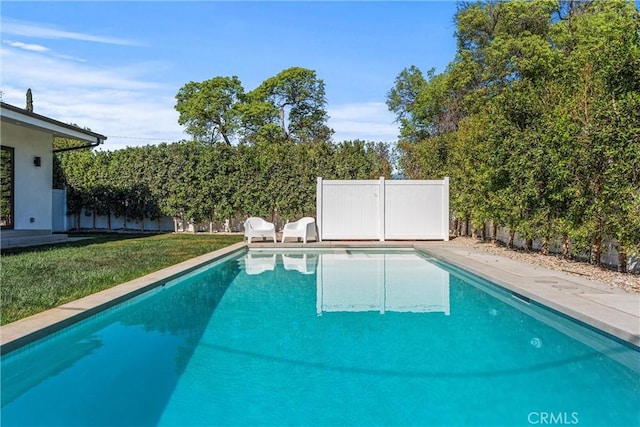 view of pool featuring a yard