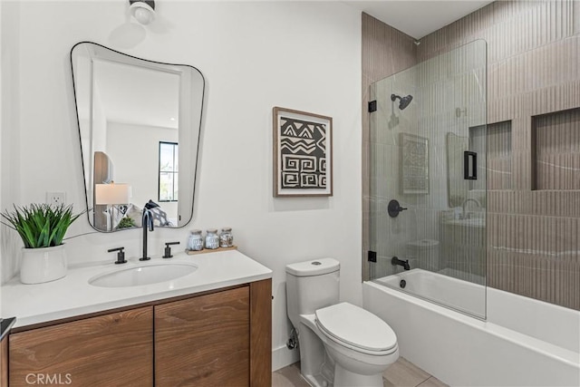 full bathroom with shower / bath combination with glass door, tile patterned floors, vanity, and toilet