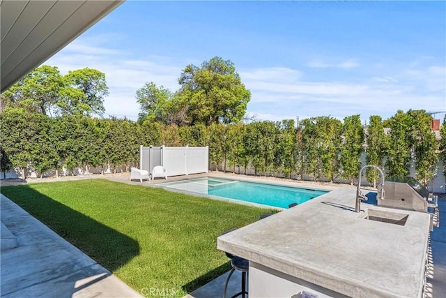 view of swimming pool with a yard and a patio