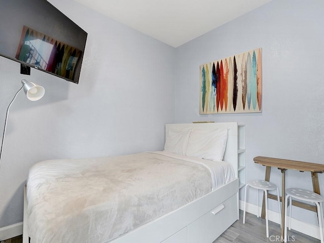 bedroom with wood-type flooring