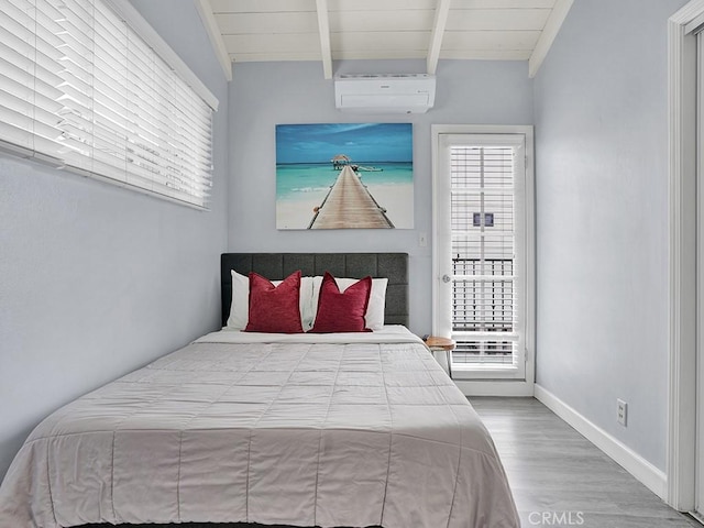 bedroom with wood-type flooring, multiple windows, vaulted ceiling with beams, and a wall mounted AC