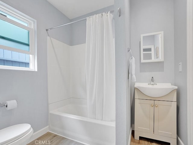 full bathroom with wood-type flooring, vanity, shower / tub combo with curtain, and toilet