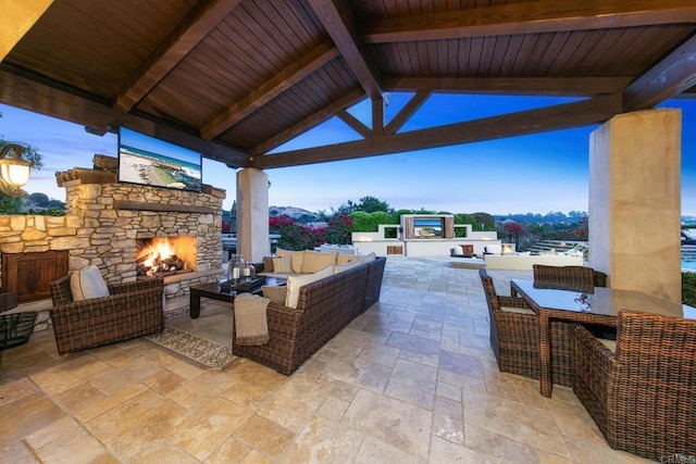 view of patio / terrace with a gazebo and an outdoor living space with a fireplace