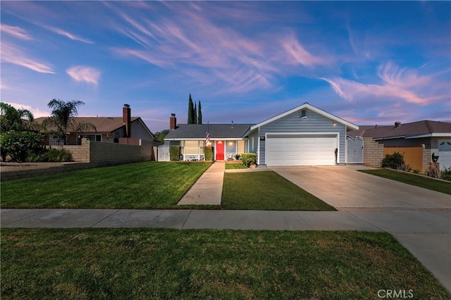 ranch-style house featuring a garage and a lawn