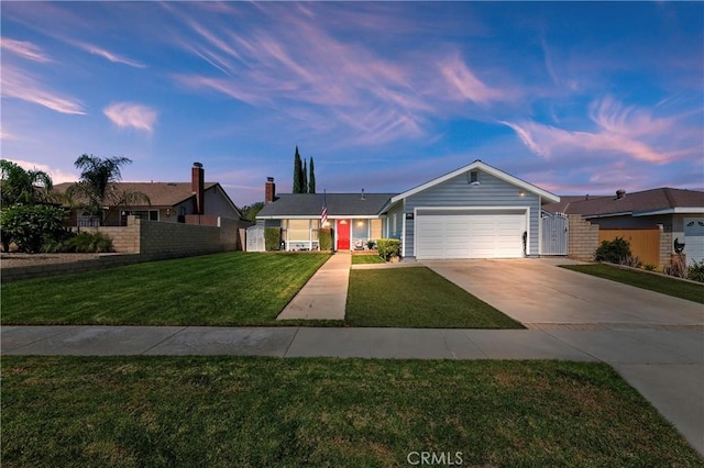 single story home with a garage and a yard