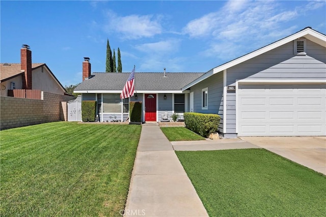 ranch-style house featuring a garage and a front yard