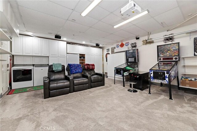 home theater room with light carpet and washer and dryer